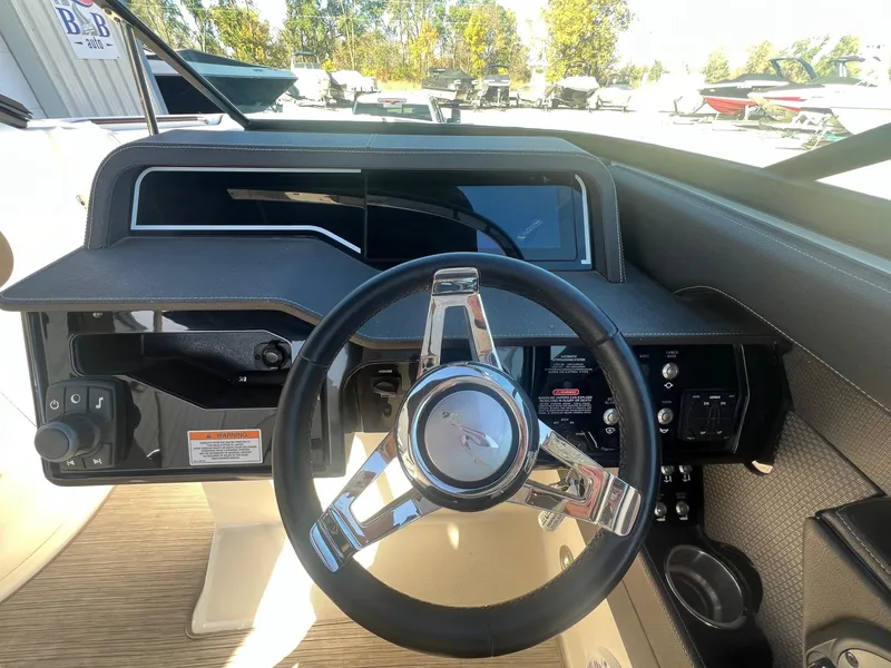 Slide: The Image of 2018 Sea Ray 280 SLX boat dashboard with steering wheel and controls. - 18