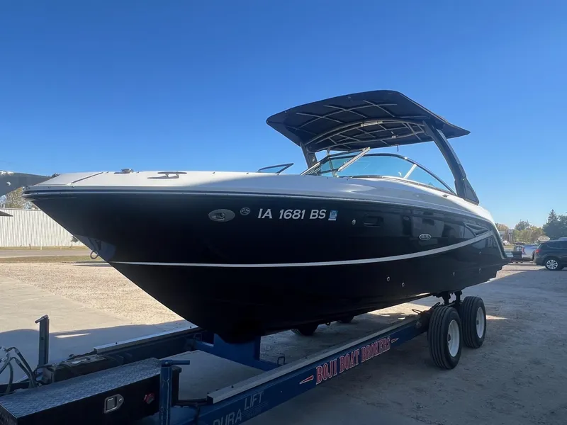 Slide: The Image of 2018 Sea Ray 280 SLX boat on trailer under clear blue sky. - 2