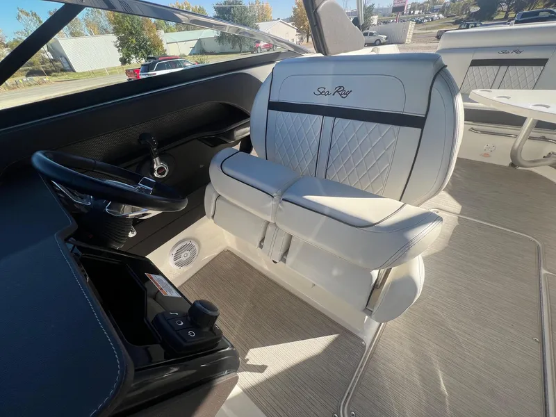 Slide: The Image of 2018 Sea Ray 280 SLX boat interior with luxury seating and steering wheel. - 26