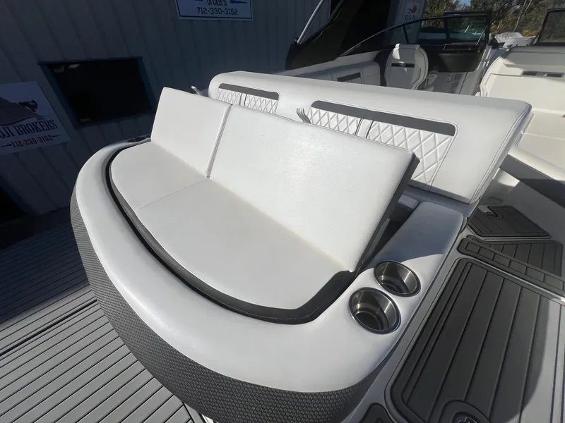 Slide: The Image of 2018 Sea Ray 280 SLX boat with white seating and cup holders on deck. - 37
