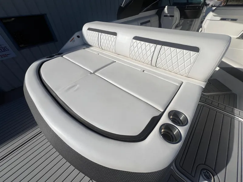 Slide: The Image of 2018 Sea Ray 280 SLX boat with white cushioned seating and cup holders. - 38