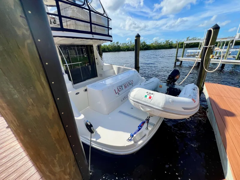 Slide: The Image of 2007 Sea Ray 52 Sedan Bridge docked with inflatable boat, sunny day. - 10
