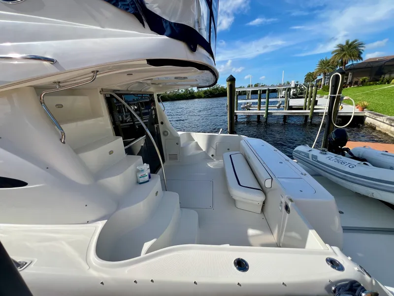 Slide: The Image of 2007 Sea Ray 52 Sedan Bridge yacht docked by a scenic waterfront. - 14