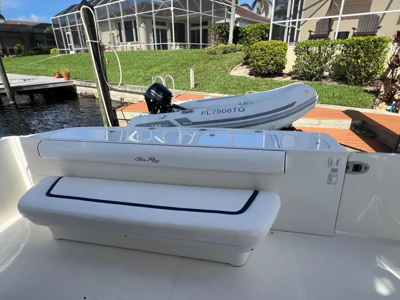 Slide: The Image of 2007 Sea Ray 52 Sedan Bridge yacht with tender on deck, docked by waterfront home. - 15