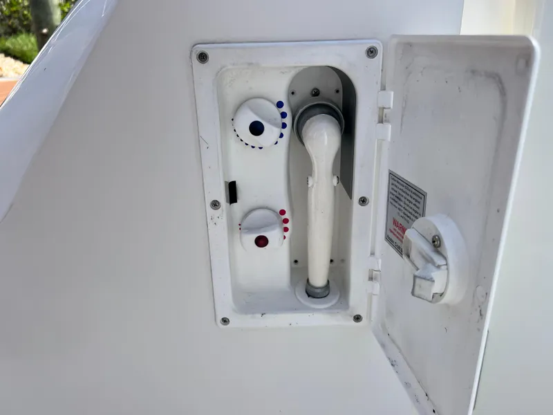 Slide: The Image of 2007 Sea Ray 52 Sedan Bridge shower controls with temperature dials and hose. - 19