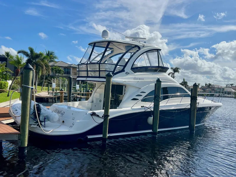 Slide: The Image of 2007 Sea Ray 52 Sedan Bridge yacht docked in sunny marina. - 2
