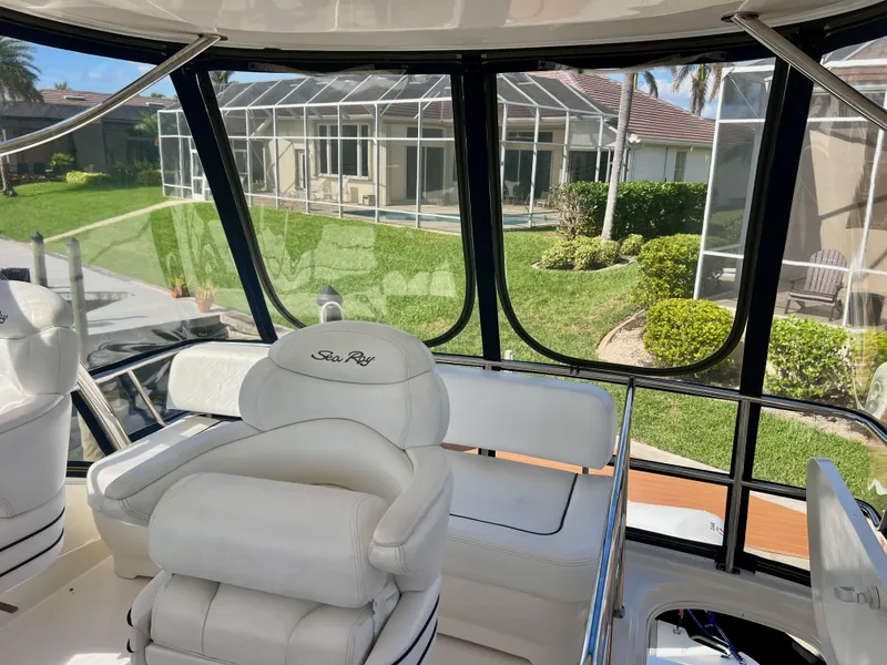 Slide: The Image of 2007 Sea Ray 52 Sedan Bridge interior with white seating and panoramic windows. - 22