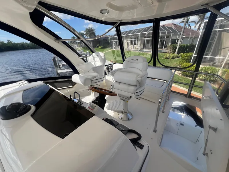 Slide: The Image of Luxurious 2007 Sea Ray 52 Sedan Bridge yacht interior with plush seating and panoramic windows. - 26