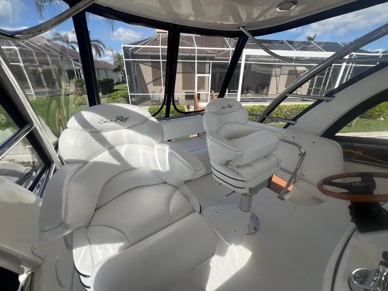 Slide: The Image of 2007 Sea Ray 52 Sedan Bridge cockpit with white leather seating and panoramic windows. - 27