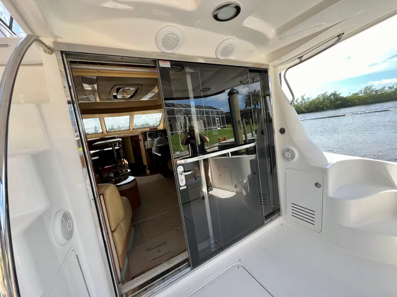 Slide: The Image of 2007 Sea Ray 52 Sedan Bridge yacht interior with sliding glass door and scenic water view. - 30
