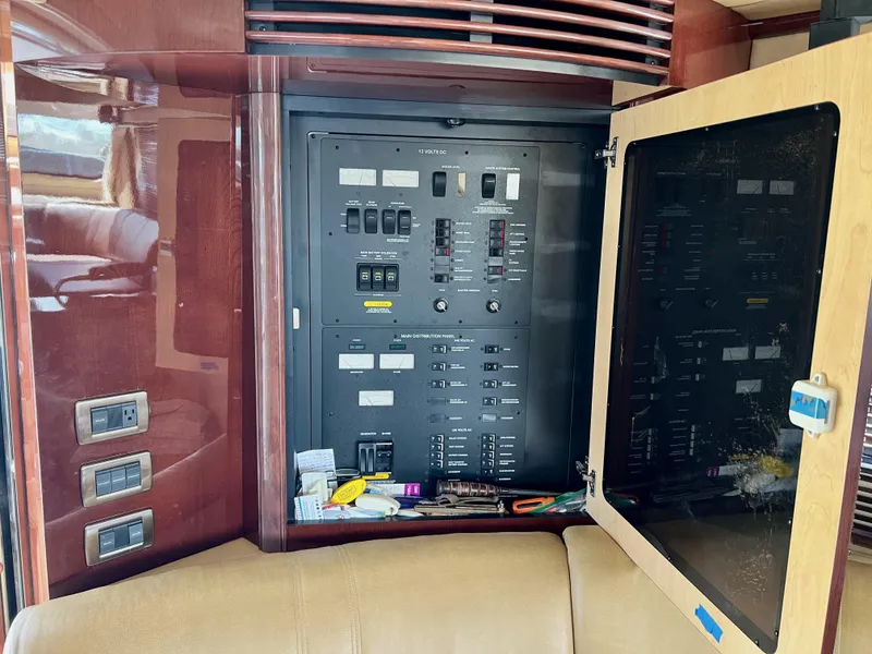 Slide: The Image of Electrical panel inside 2007 Sea Ray 52 Sedan Bridge yacht, featuring switches and controls. - 34