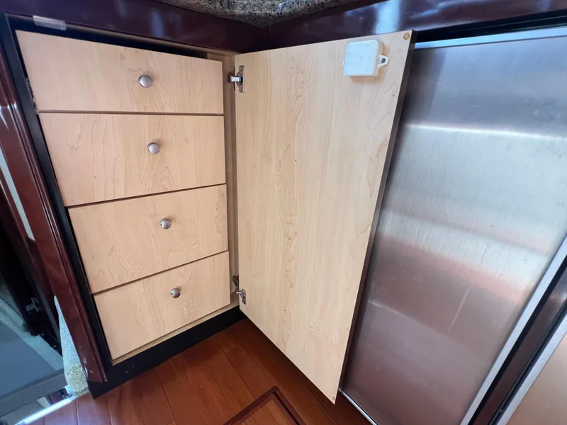 Slide: The Image of Wooden cabinet with four drawers on a 2007 Sea Ray 52 Sedan Bridge yacht. - 41