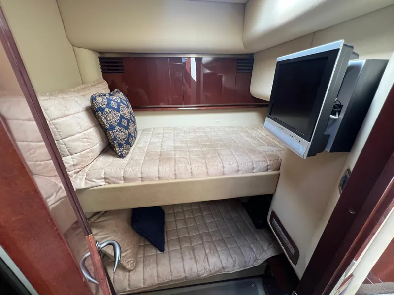 Slide: The Image of 2007 Sea Ray 52 Sedan Bridge cabin with bunk beds and wall-mounted TV. - 45