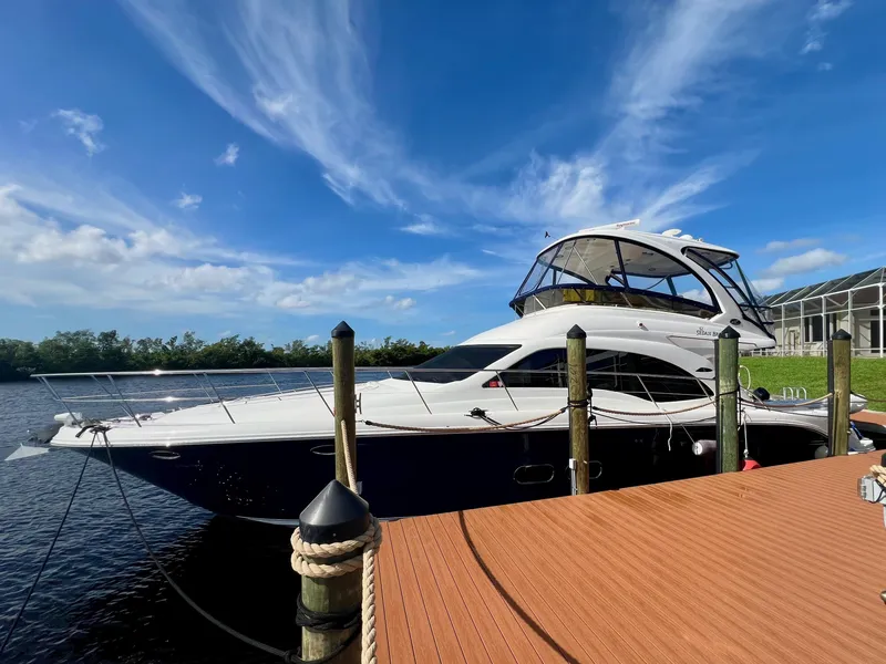 Slide: The Image of 2007 Sea Ray 52 Sedan Bridge yacht docked under a clear blue sky. - 5