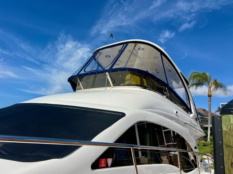 Slide: The Image of 2007 Sea Ray 52 Sedan Bridge yacht under clear blue sky. - 6