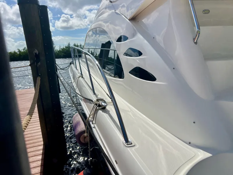 Slide: The Image of 2007 Sea Ray 52 Sedan Bridge yacht docked by the water. - 8