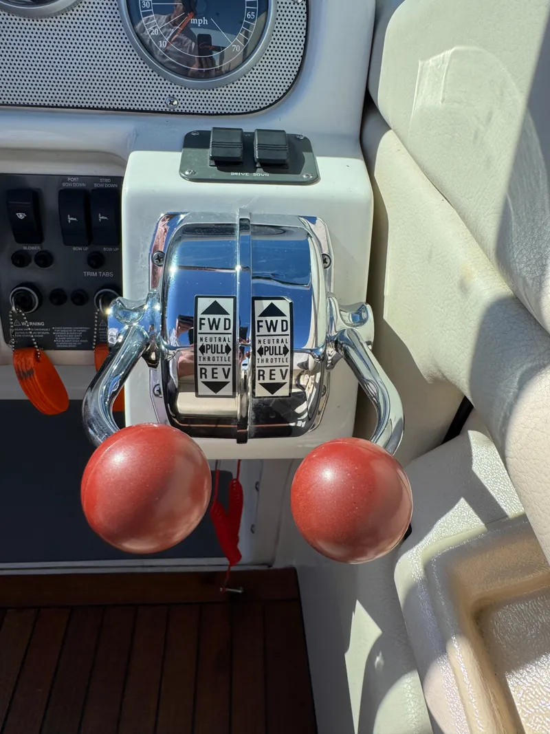 Slide: The Image of Throttle controls of a 2005 Chris-Craft Corsair 28 boat with wooden handles. - 10