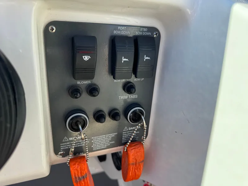 Slide: The Image of Control panel of a 2005 Chris-Craft Corsair 28 boat with switches and keys. - 11