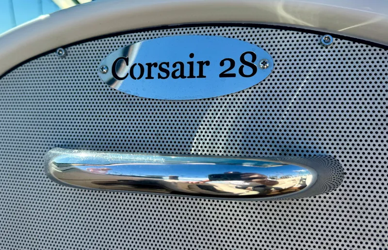 Slide: The Image of 2005 Chris-Craft Corsair 28 nameplate with chrome handle detail. - 13