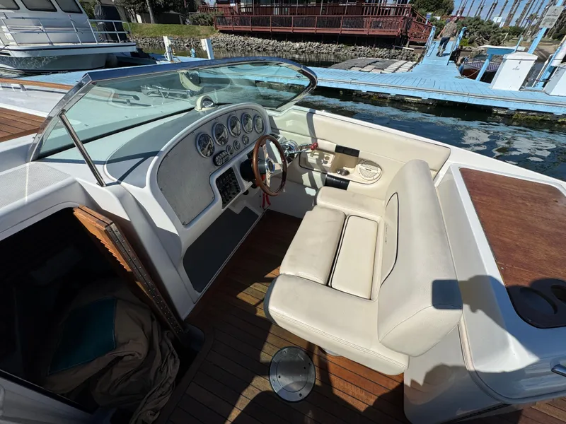 Slide: The Image of 2005 Chris-Craft Corsair 28 boat interior with steering wheel and dashboard at dock. - 18