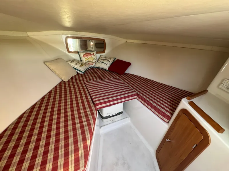 Slide: The Image of 2005 Chris-Craft Corsair 28 cabin with plaid cushions and wooden accents. - 22