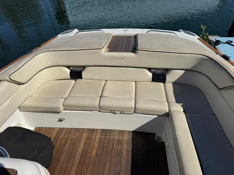 Slide: The Image of 2005 Chris-Craft Corsair 28 boat interior with beige seating and wooden flooring. - 4