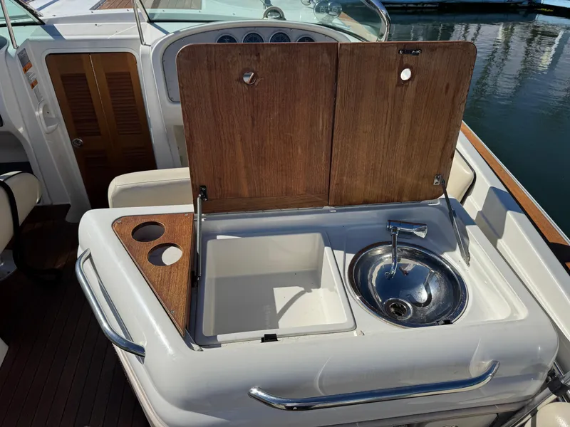 Slide: The Image of 2005 Chris-Craft Corsair 28 boat sink and counter with wooden cover. - 5
