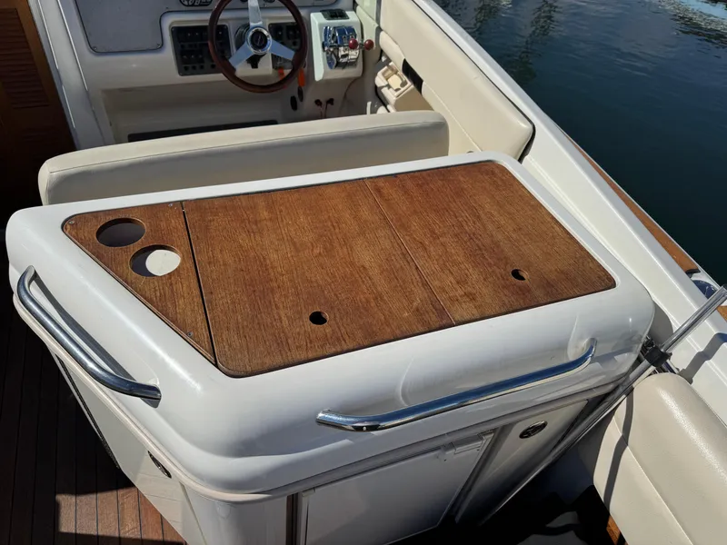 Slide: The Image of 2005 Chris-Craft Corsair 28 boat interior with wooden panel and steering wheel. - 6