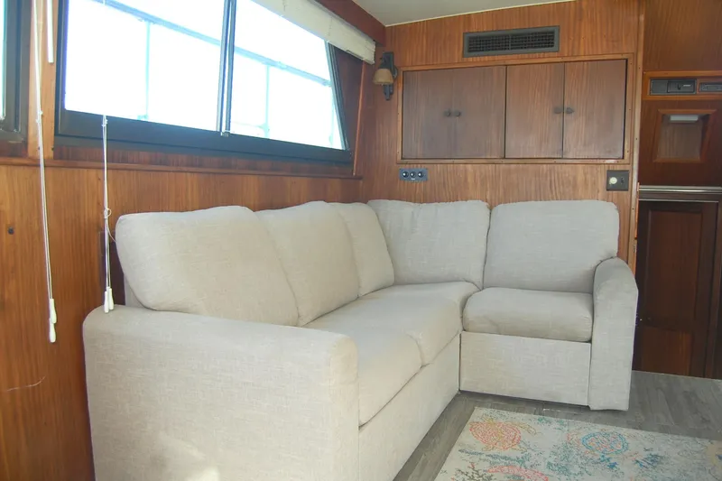 Slide: The Image of Beige sofa in 1981 Hatteras 48 Cockpit MY yacht interior with wood paneling. - 12