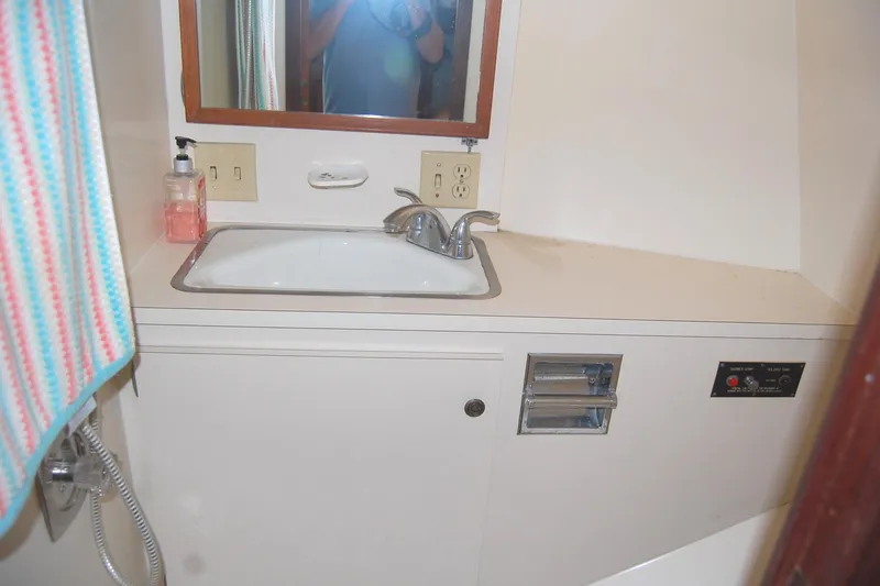 Slide: The Image of 1981 Hatteras 48 Cockpit MY bathroom sink with mirror and countertop. - 32