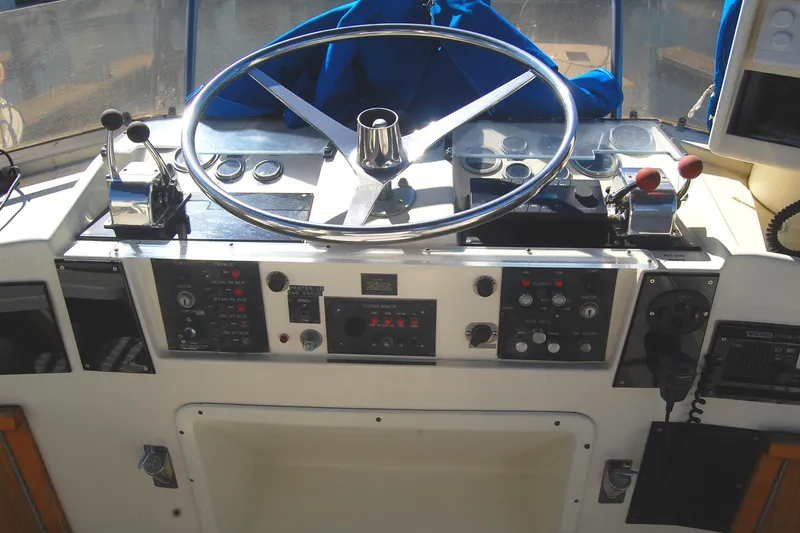 Slide: The Image of 1981 Hatteras 48 Cockpit MY helm with steering wheel and control panel. - 40