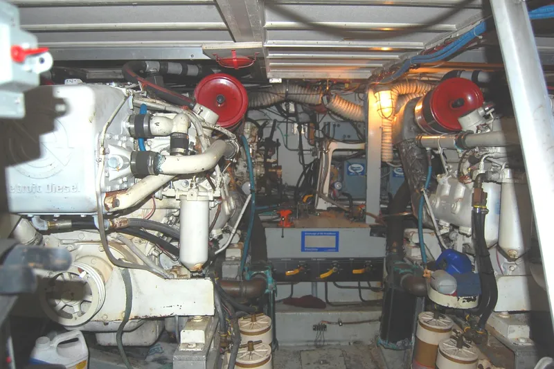 Slide: The Image of Engine room of 1981 Hatteras 48 Cockpit MY with dual engines and mechanical components. - 49