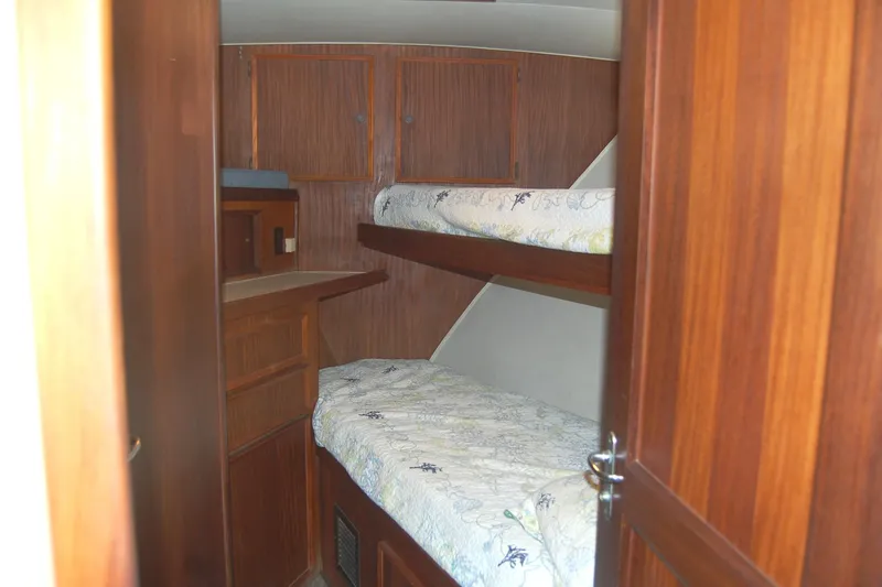 Slide: The Image of 1981 Hatteras 48 Cockpit MY cabin with wooden interior and bunk beds. - 7