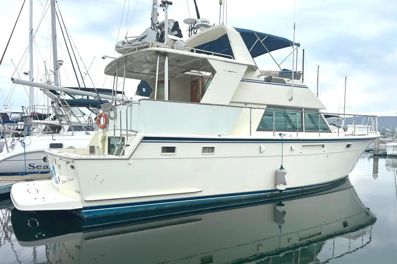Slide: The Image of 1981 Hatteras 48 Cockpit MY yacht docked at marina, side view. - 1