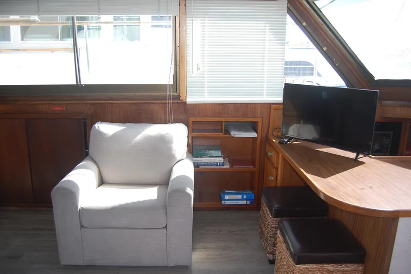 Slide: The Image of Interior of 1981 Hatteras 48 Cockpit MY with armchair, TV, and wooden furnishings. - 14