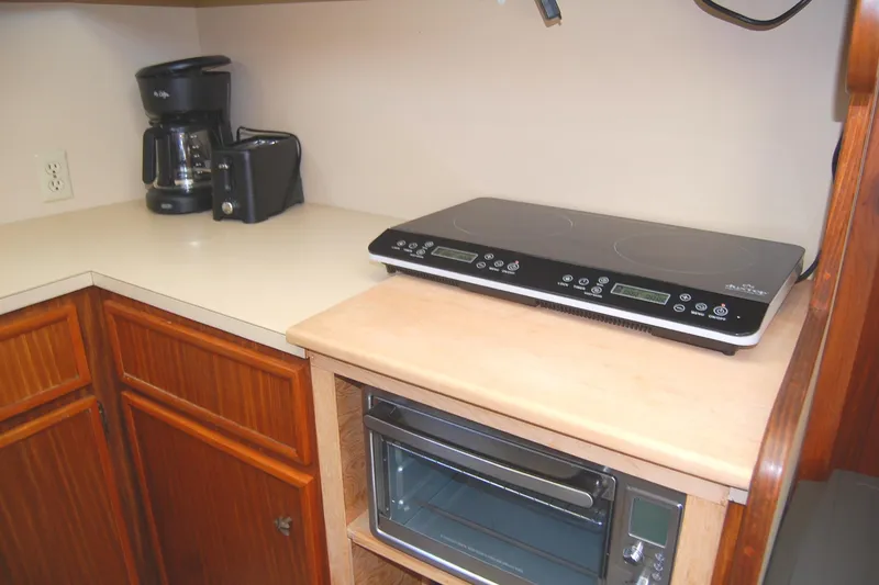 Slide: The Image of Kitchen area in 1981 Hatteras 48 Cockpit MY with appliances and wooden cabinetry. - 20