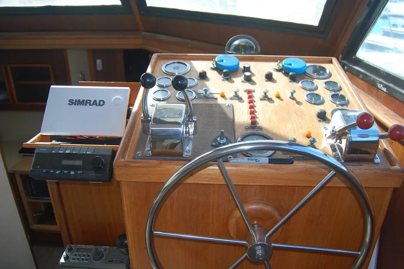 Slide: The Image of 1981 Hatteras 48 Cockpit MY helm with steering wheel and control panel. - 30