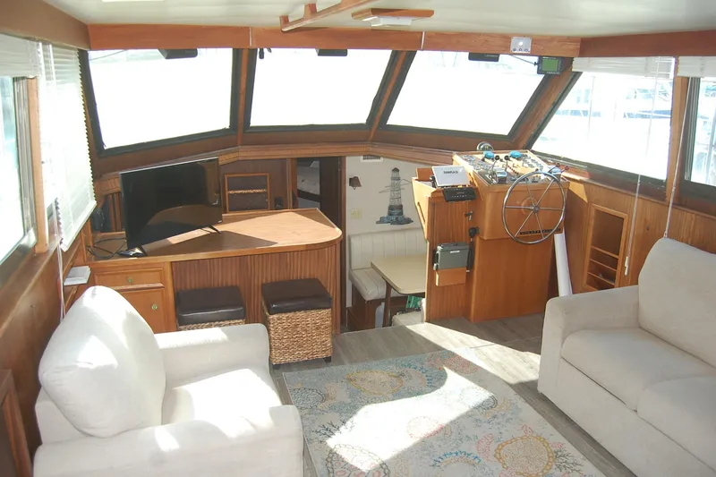 Slide: The Image of Interior of 1981 Hatteras 48 Cockpit MY yacht with seating, helm, and large windows. - 4