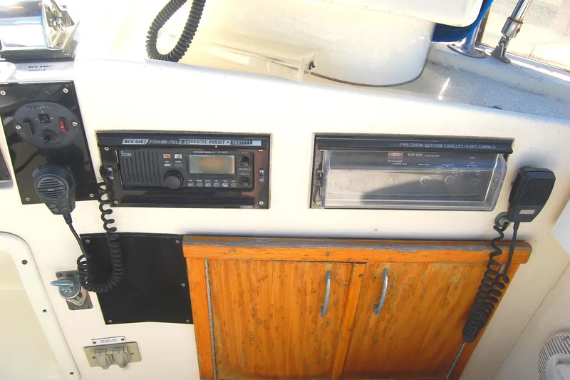 Slide: The Image of Control panel of 1981 Hatteras 48 Cockpit MY with radio and wooden cabinet. - 42