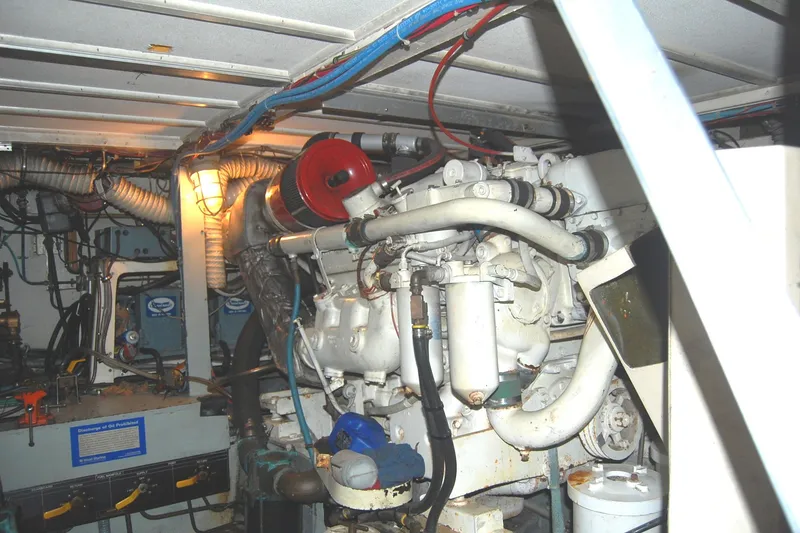 Slide: The Image of Engine room of 1981 Hatteras 48 Cockpit MY with visible machinery and wiring. - 50