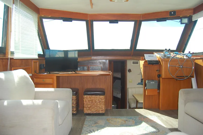 Slide: The Image of Interior of 1981 Hatteras 48 Cockpit MY yacht with helm, seating, and TV. - 9