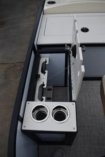 Slide: The Image of 2023 Lowe SF212 Walk-Through boat interior with cup holders and storage compartment. - 17