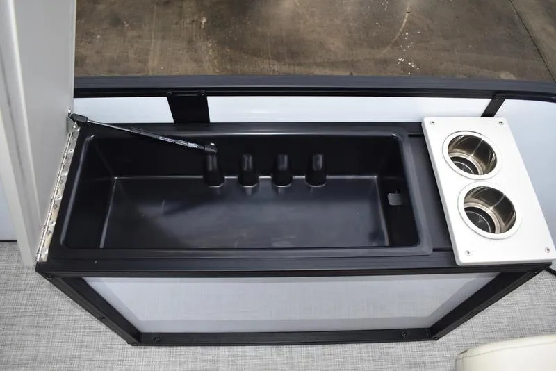 Slide: The Image of 2023 Lowe SF212 Walk-Through boat interior with storage compartment and dual cup holders. - 18