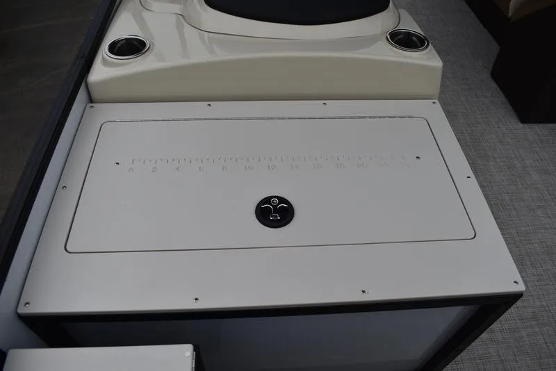 Slide: The Image of 2023 Lowe SF212 Walk-Through boat interior with storage compartment and cup holders. - 20