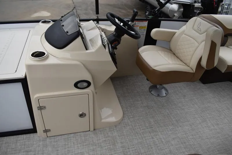 Slide: The Image of 2023 Lowe SF212 Walk-Through boat interior with steering console and cushioned seat. - 22