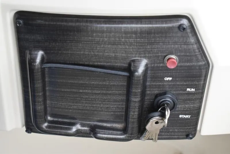 Slide: The Image of Control panel of 2023 Lowe SF212 Walk-Through boat with ignition keys and start button. - 24