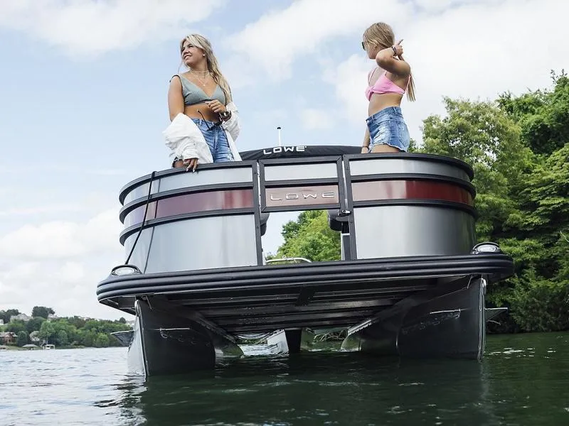 Slide: The Image of 2023 Lowe SF212 Walk-Through pontoon boat on water with two people enjoying the view. - 33
