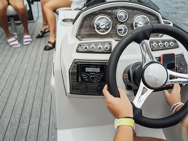 Slide: The Image of 2023 Lowe SF212 Walk-Through boat dashboard with steering wheel and control panel. - 39