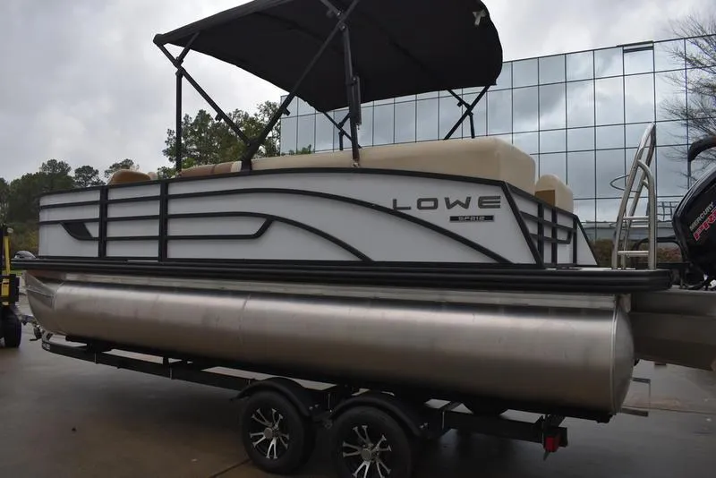 Slide: The Image of 2023 Lowe SF212 Walk-Through pontoon boat with canopy on trailer. - 7