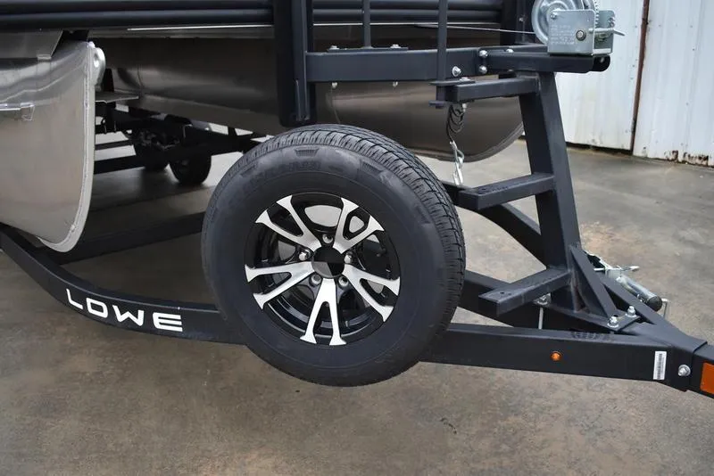 Slide: The Image of Trailer wheel of 2023 Lowe SF212 Walk-Through boat on concrete surface. - 8
